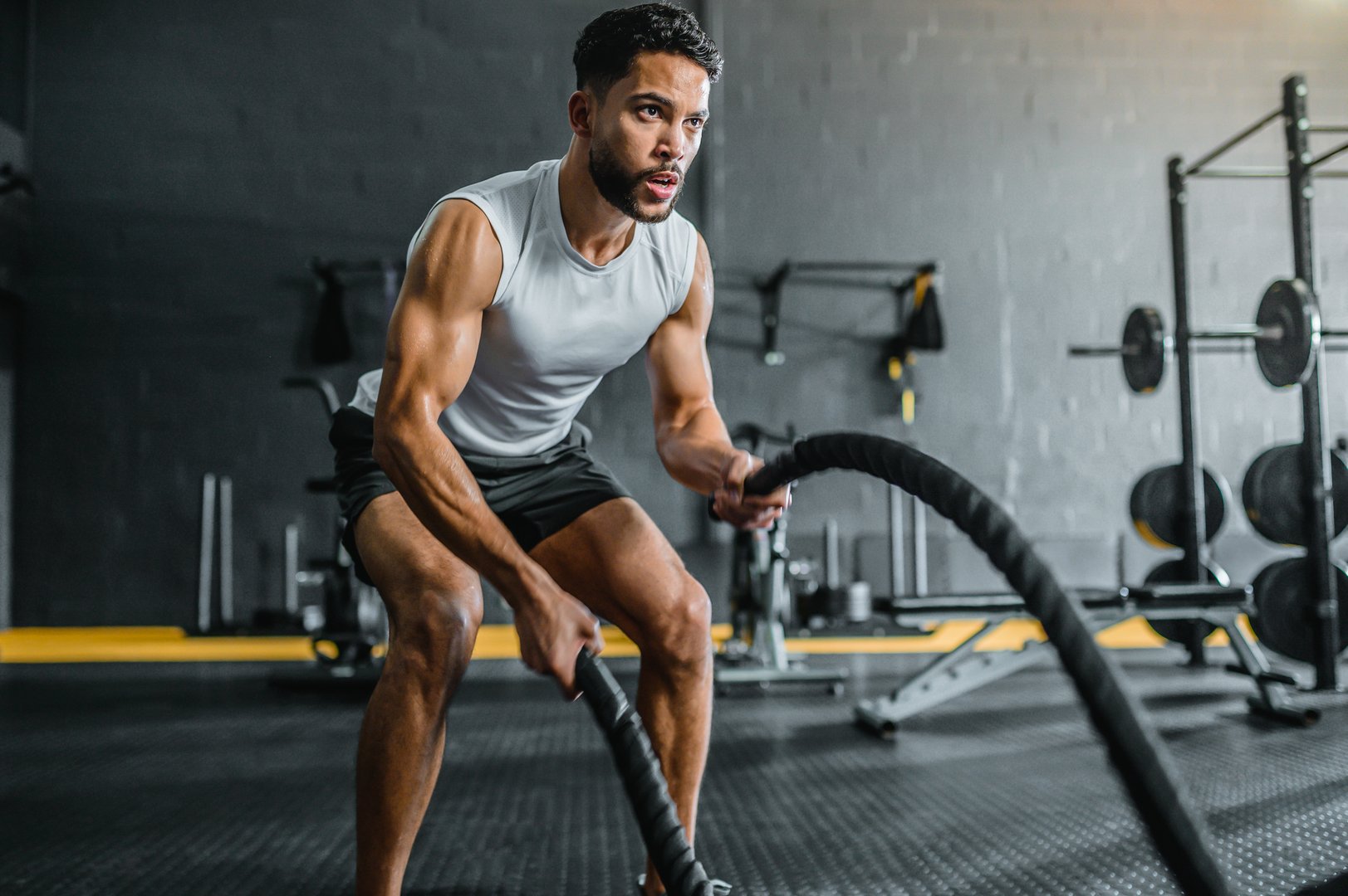 Athletic man training with battle ropes