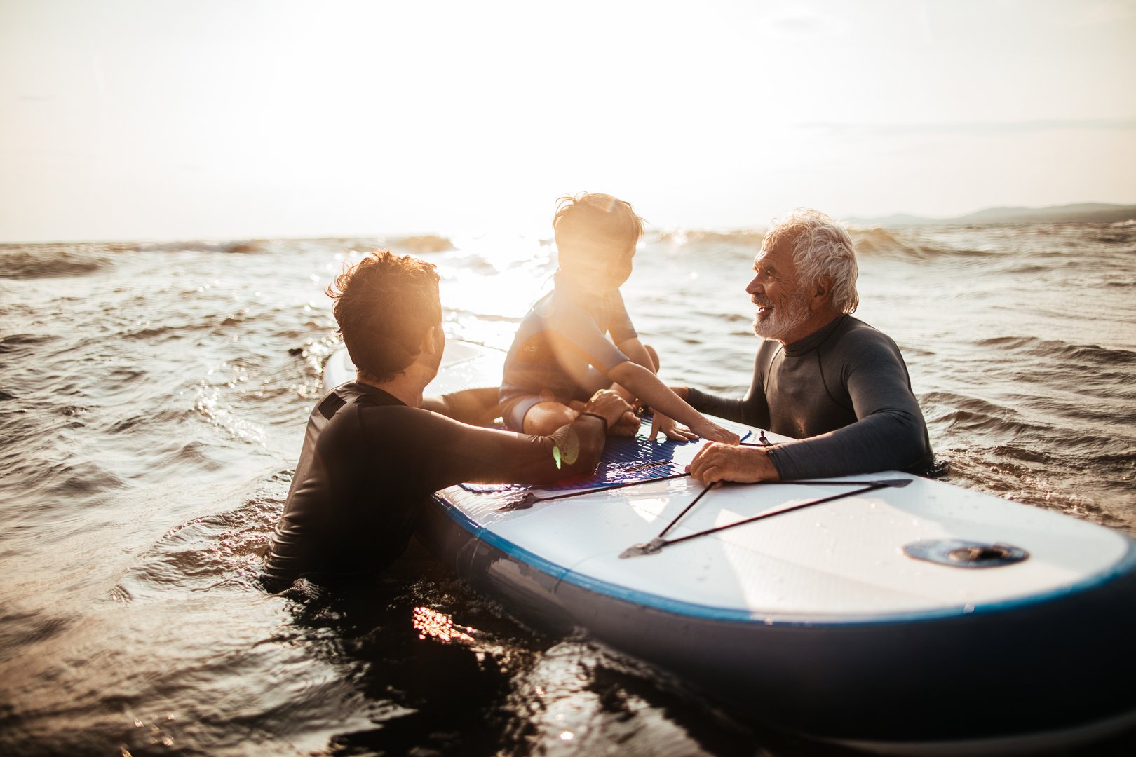 Men in wetsuits by the ocean